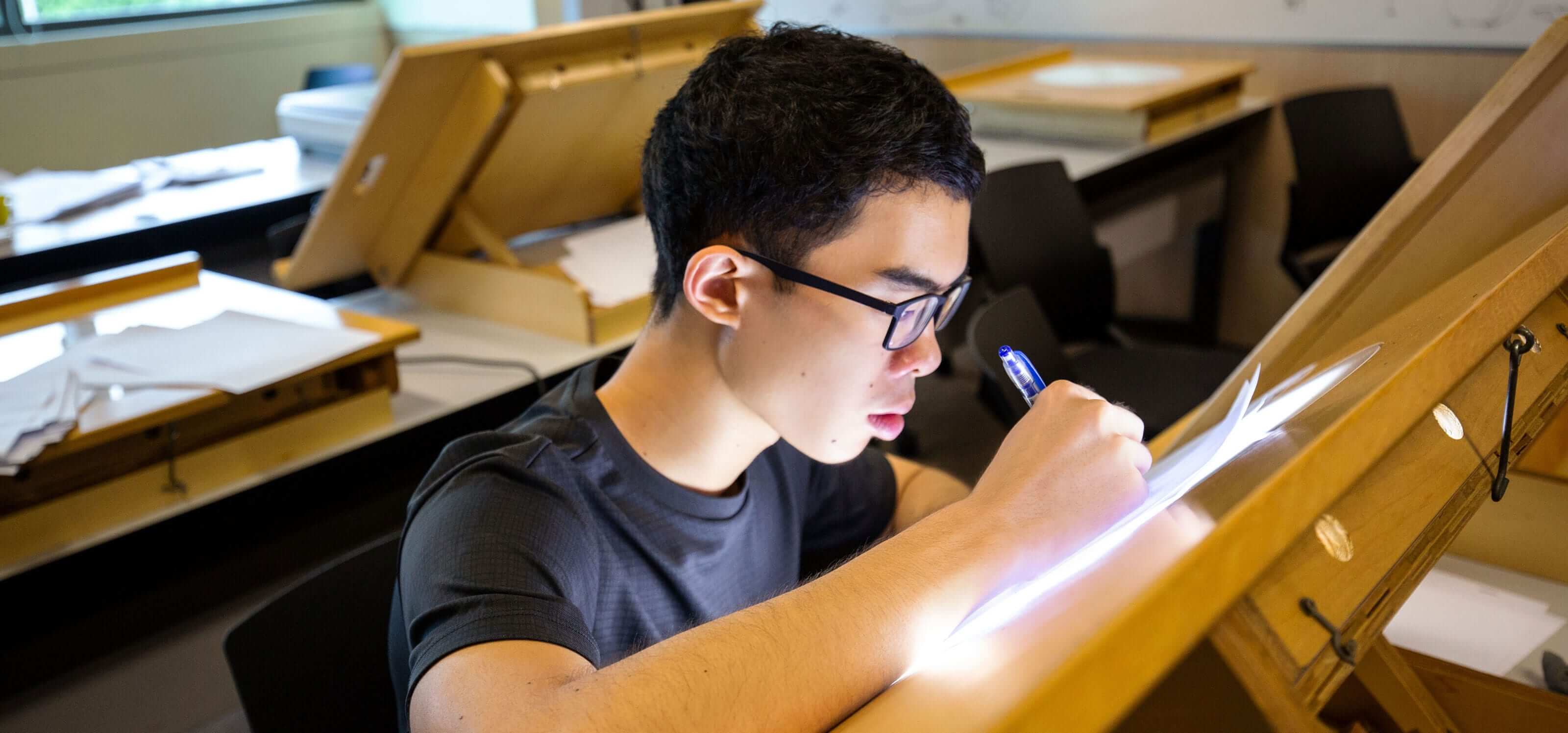 A DigiPen (Singapore) student concentrates as he works on an animation lightbox
