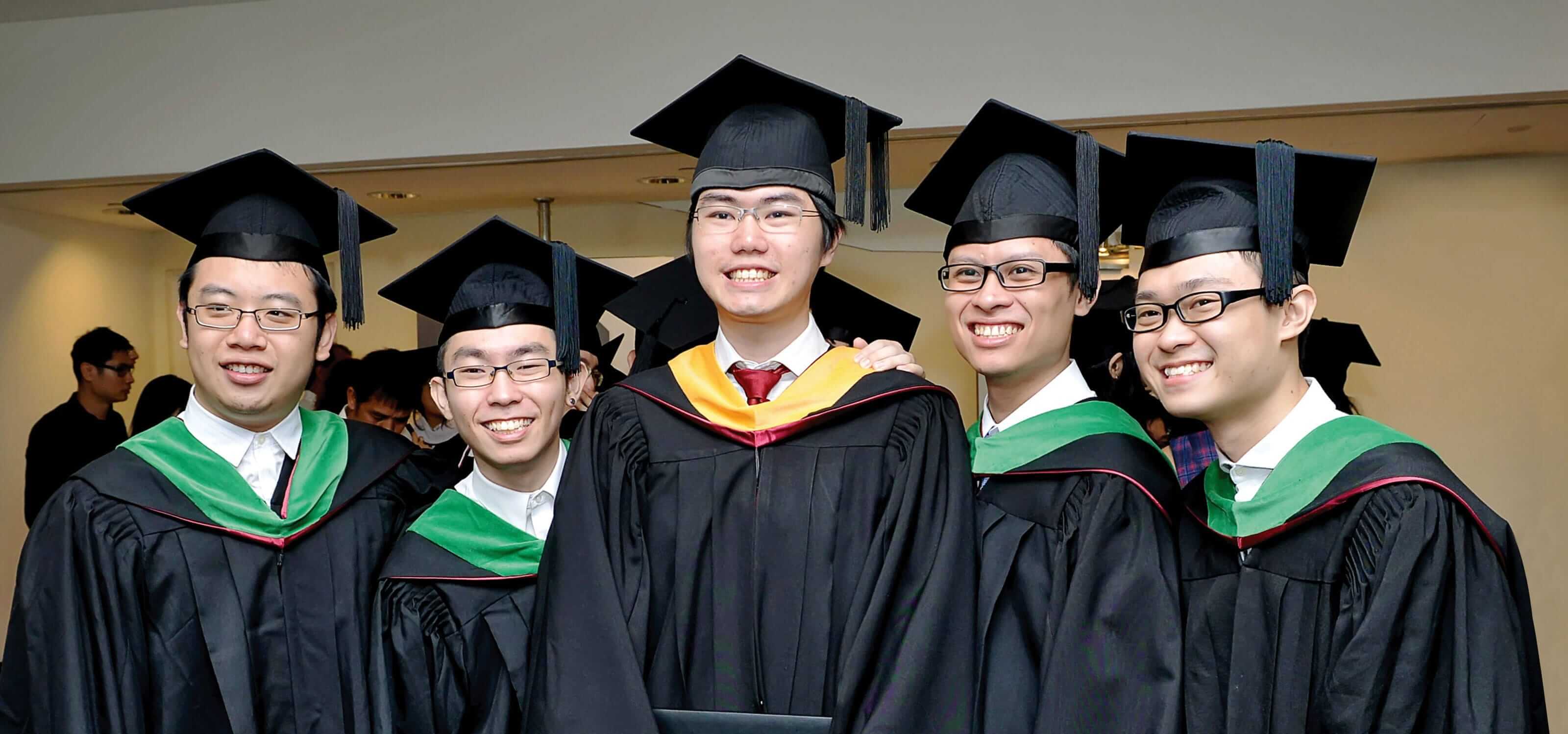 A group of DigiPen (Singapore) graduates smiling proudly at Commencement