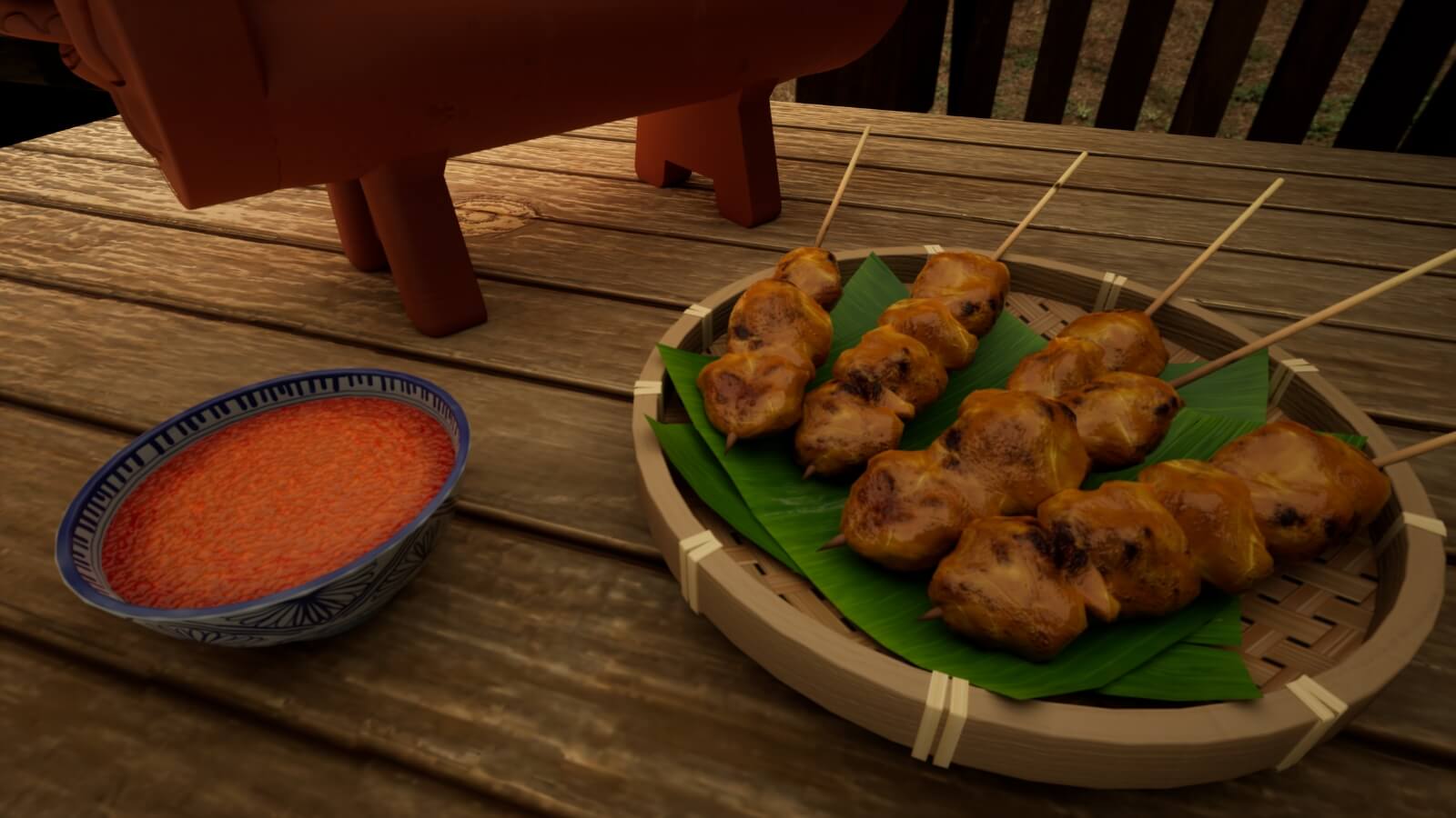 A close up of satay and a cup of sauce.