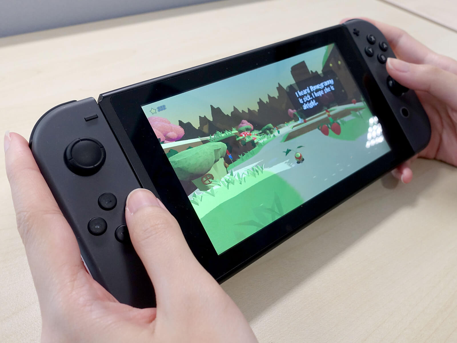 Close-up of two hands holding a Nintendo Switch