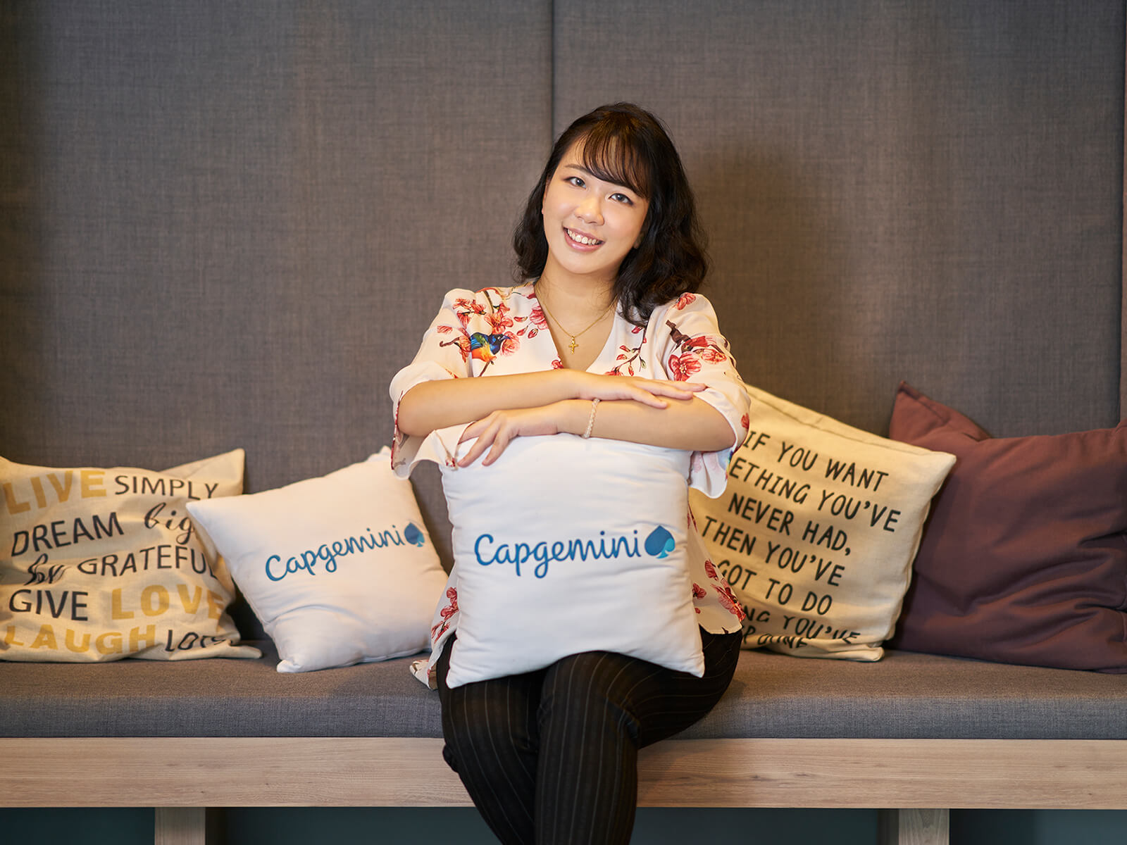 DigiPen (Singapore) graduate Sherilyn Kan smiles in an alcove with pillows